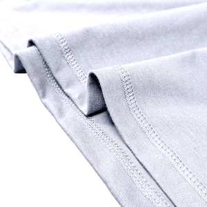 Close-up of double-needle stitching on light grey men's cotton knit henley shirt