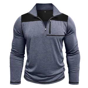 Detail of men's quarter-zip pullover showing contrast shoulder panels and chest pocket