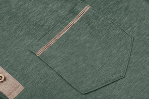 Detail of army green Henley shirt showing a pocket with khaki stitching and button