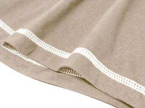 Macro shot of khaki knit shirt edge featuring durable white double row stitching details