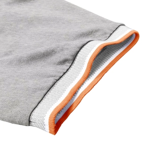 Detail of color-block polo shirt sleeve with orange and white striped ribbed cuffs