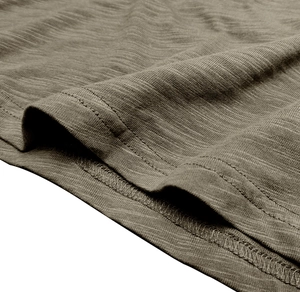Detailed macro view of high-quality double-needle stitching on olive green henley shirt fabric