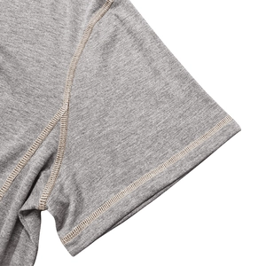 Detail showing high-quality flatlock stitching on the grey marl cotton henley shirt