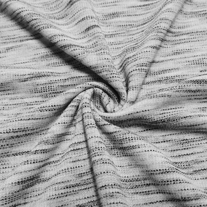 Close-up of soft grey marl knit fabric showing fine texture and spiral draping detail