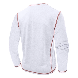 Close-up of men's grey long sleeve Henley shirt featuring vibrant orange contrast stitching
