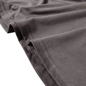 Detailed macro view of the twin-needle hem stitching on a dark grey knit polo shirt