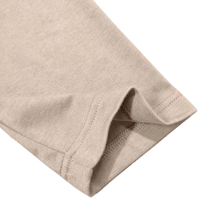 Detailed macro view of the knitted sleeve cuff and double stitching on oatmeal henley shirt