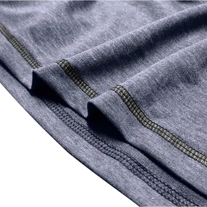 Detail of dark gray heather knit fabric with reinforced flatlock stitching on jacket