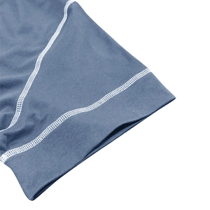 Close-up of flatlock stitching and soft knit fabric on blue muscle Henley shirt