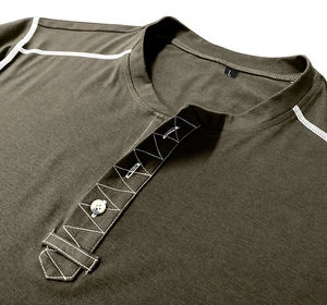 Detail of olive Henley shirt showing white contrast stitching and white button closure