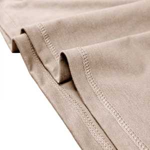 Detailed view of beige knitted fabric hem with precise double-needle stitching quality
