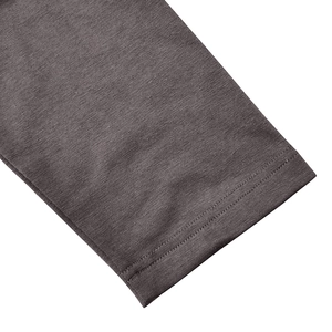 Detail of dark grey knit polo shirt sleeve with durable double-needle stitching quality