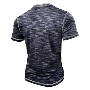 Detail view of navy blue textured knit fabric with decorative stitching on men's t-shirt