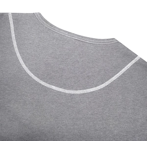 Close-up of grey knit Henley shirt collar featuring white contrast stitching detail