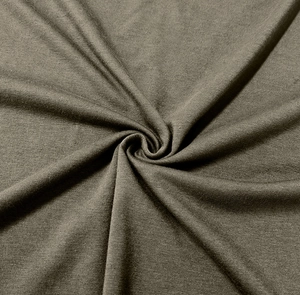 Close-up of olive green knitted fabric showing fine texture and soft drape on men's shirt