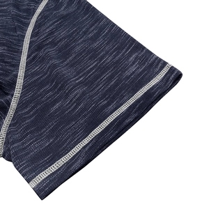 Detailed macro shot of flatlock stitching on space-dye blue fabric sleeves