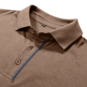 Detail of brown cotton Polo shirt collar with size S tag and contrast stitching