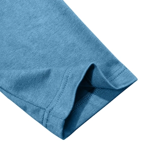 Detailed close-up of double-needle stitching on the hem of a blue knit Henley shirt