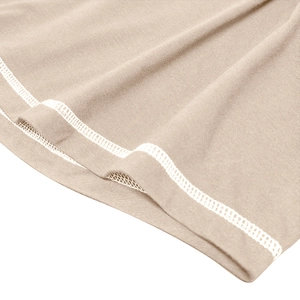 Close-up of beige knitted muscle Henley shirt showing high-quality double-needle hem stitching