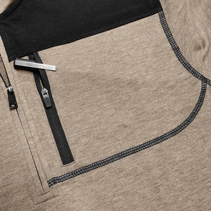 Detail of outdoor jacket showing high-quality stitching and black zipper pocket