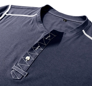 Detail of navy blue Henley shirt neckline featuring white stitching and 3-button placket