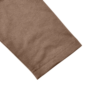 Detailed macro view of dark brown high-density knit fabric and double-needle stitching
