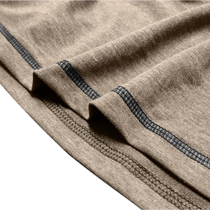 Macro detail of high-quality double-stitch sewing on the brown tactical sweater hem