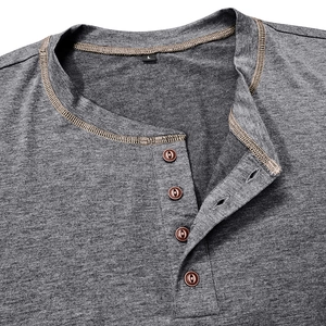 Detail of dark gray Henley T-shirt neckline with four brown buttons and contrast stitching