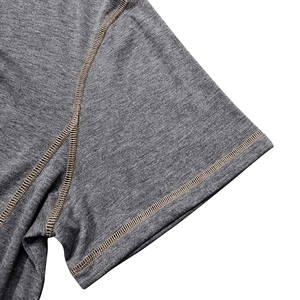 Macro detail of the dark grey knit fabric with durable flatlock reinforced stitching