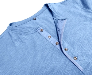 Detail of light blue Henley shirt neckline showing wood buttons and slub texture