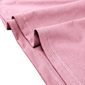 Detail of pink cotton knit fabric with durable double-needle flatlock stitching on the hem