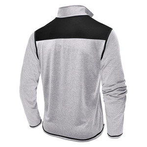 Detail view of contrast back panel and ribbed cuffs on men's gray standing collar jacket