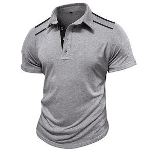 Detail of grey polo shirt featuring black shoulder piping and a contrast button placket