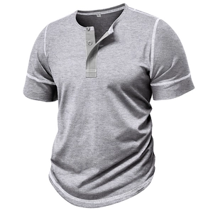 Macro shot of grey Henley shirt showing contrast white stitching and knit fabric texture