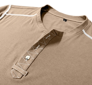 Detail of white zigzag stitching and light button on a men's brown cotton Henley shirt