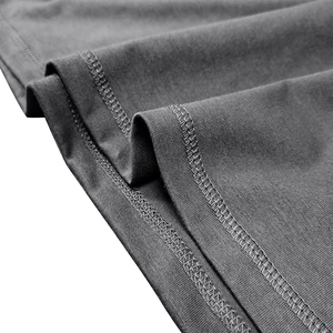 Close-up of double-needle stitching on the hem of a dark grey long sleeve Henley shirt