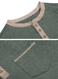 Detail of Henley neckline with wooden buttons and contrast trim on green knit tee
