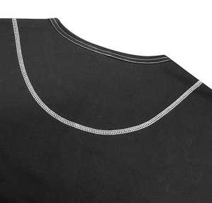 Detail of crew neck Henley shirt with white contrast stitching on black cotton fabric
