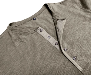 Detail of five-button Henley collar with slub texture on olive green long sleeve shirt