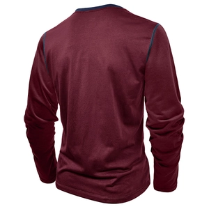 Macro detail of men's burgundy long sleeve Henley shirt with contrast navy stitching