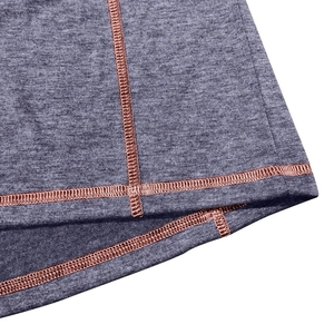Detail of grey marl fabric with orange flatlock stitching and professional finish