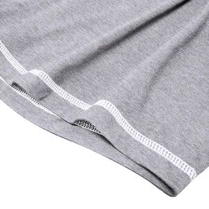 Close-up of contrast white stitching on gray marl knit muscle henley shirt hem