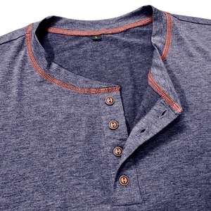 Detail of dark blue knit Henley collar with orange stitching and vintage buttons