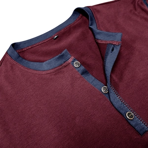 Detail of burgundy Henley shirt with navy contrast collar and three wooden buttons