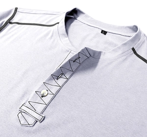 Close-up of men's Henley shirt neckline with button detail and geometric contrast stitching