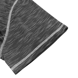 Detailed macro shot of dark grey marled fabric with precise white flatlock stitching detail