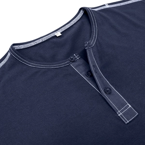 Detail of navy Henley shirt neckline featuring three buttons and white contrast stitching