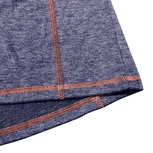 Detail of grey-blue knit fabric featuring contrast pink stitching on the hemline
