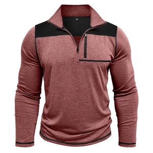 Detail of red-brown sweatshirt with black shoulder panels and vertical chest zip pocket