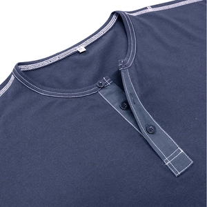 Close-up of navy blue Henley shirt collar with three buttons and white contrast stitching detail